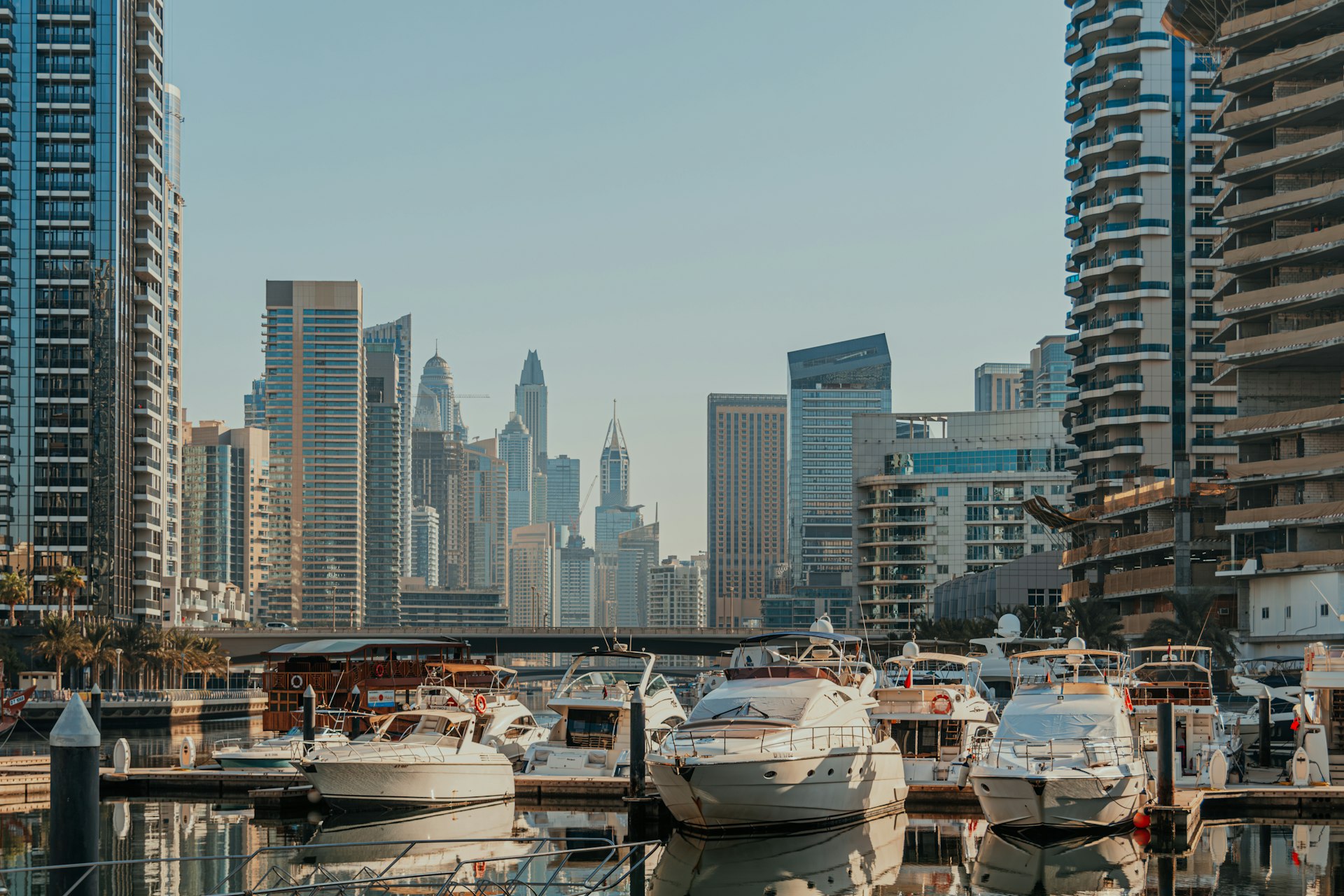 A harbor filled with lots of boats next to tall buildings